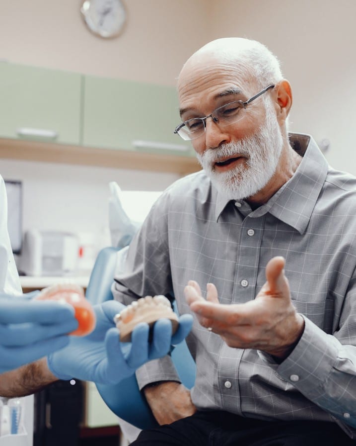 Dentist checking the fit of a denture at Ooi Dan Rakan